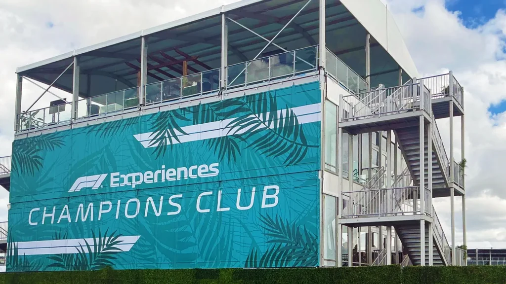 Large Tent with vinyl wrap on it with text and logo of F1 Experiences Champions Club